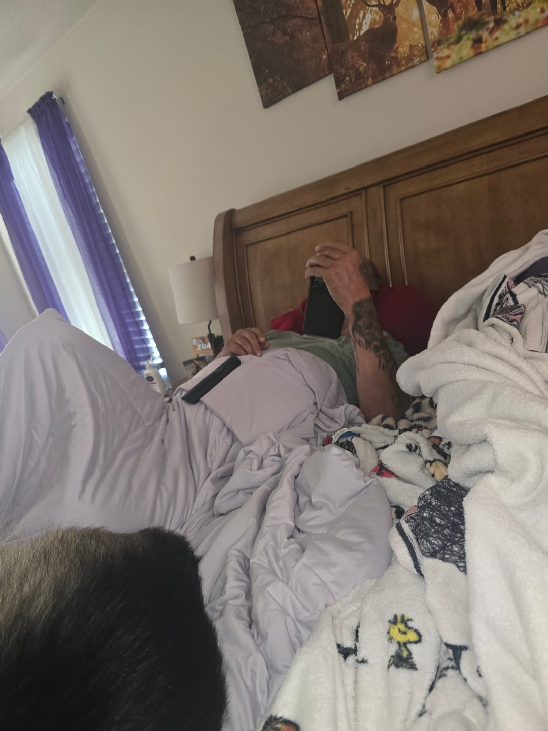 Customer relaxing in bed under the BreezeComfort comforter